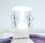Boucles d'oreilles pendantes originales et modernes en forme créoles avec pendentif en hématite couleur arc-en-ciel. Couleur neutre aux multi reflets. Bijou fait main et modèle unique.
