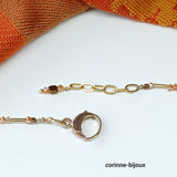 Collier orange composé de perles de verre et d'un pendentif laiton en forme de papillon. Ce collier fantaisie est ajustable en longueur avec un fermoir en metal doré.Ce bijou est élégant,unique et original. 