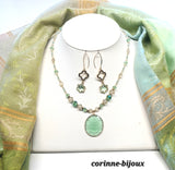Parure de bijoux composé d'un colllier pendentif vert clair en verre  et perles beiges translucides assorties de  boucles d'oreilles longues vert clair en forme de fleur et tréfle.